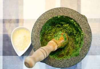 Preparation of traditional Pesto alle Genovese - with basil, olive oil, pine nuts, parmesan cheese...