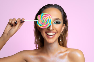 Beauty fashion model girl wiht colourful lollipop. Beautiful young woman portrait.