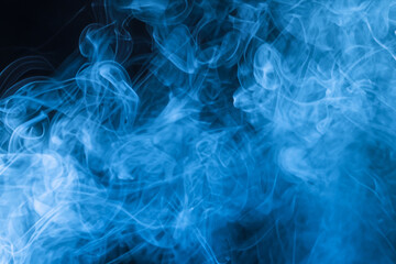 Smoky Blue Background. Blue smoke abstract background close up. Texture of smoke vape on black background.