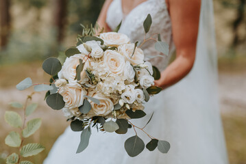 wedding bouquet in hands of bride