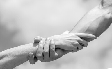 Lending a helping hand. Hands of man and woman reaching to each other, support. Solidarity, compassion, and charity, rescue. Couple of helping and praying hand. Rescue, helping gesture or hands