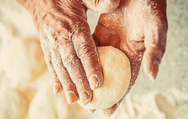 Woman kneading and making a pie. Homemade cakes dough in the women's hands. Process of making pies, hand. Hands pie dough. Cooks dough for baking, pieces of raw dough - obrazy, fototapety, plakaty