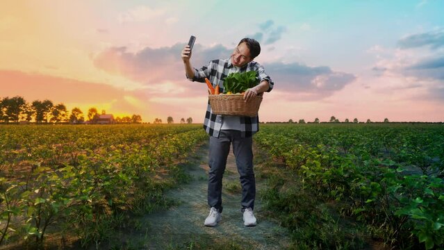 Full Body Of Asian Male Farmer With Vegetable Basket Taking Selfie By Smart Phone In Field