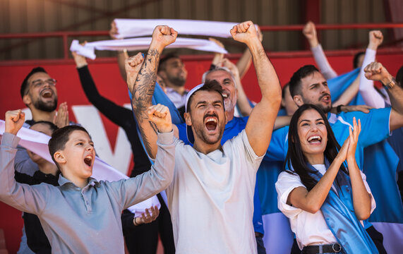 Football / soccer fans are cheering for their team at the stadium on the match