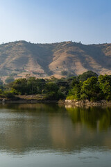 Fototapeta premium isolated mountain range with pristine lake reflection at morning from flat angle