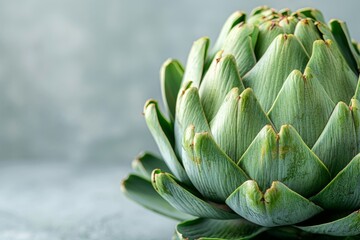 Fototapeta premium A close-up of a fresh artichoke its layered leaves and unique texture contrasted against a bright