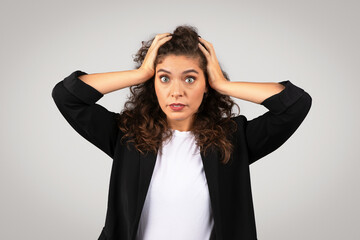 Stressed young woman holding her head