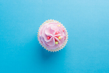 Colorful celebration background with cupcake. Minimal party concept. Top view.