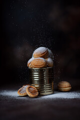 Delicious homemade cookies nuts with boiled condensed milk in a tin with powdered sugar