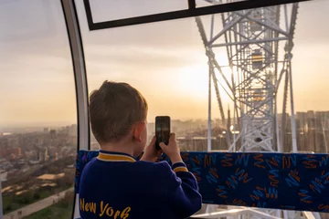 Deurstickers Boy on the Ferris Wheel © Sergey