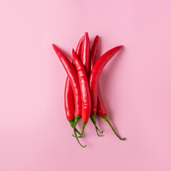 Creative layout of chili pepper on pink background. Minimal food