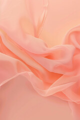 Obraz premium Soft coral chiffon fabric floating on a warm pastel background, ideal for fashion and textile design with a sense of gentle movement and fluidity, offering ample copy space