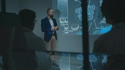 Full shot with reflection effect of Middle Eastern male scientist presenting innovative research to doctors in white coats at medical conference, with slides on projector screen, audience applauding