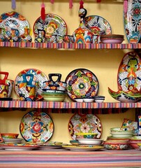 picturesque Mexican market, colourful plates,c