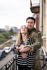 Ukrainian military man hugs his wife