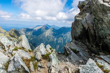 Rocky cliff overlooking a majestic mountain range. High Tatra Mountains, Slovakia.
