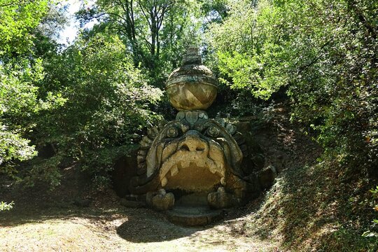 Bomarzo, Viterbo, Lazio, Italy - 08.25.2020: Ancient sculpture of the head of Proteo Glauco at the famous Parco dei Mostri, also called Sacro Bosco or Giardini di Bomarzo. Monsters park