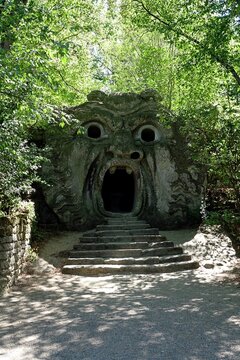 Bomarzo, Viterbo, Lazio, Italy - 08.25.2020: Orcus mouth sculpture at famous Parco dei Mostri (Park of the Monsters), also named Sacro Bosco (Sacred Grove) or Gardens of Bomarzo in Bomarzo