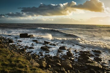 Rugged rocky shoreline on Isle of Wight island, with powerful white-capped waves crashing against it - Powered by Adobe