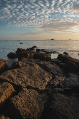 Peaceful beach sunrise with dazzling ocean backdrop and rocky shore in Isle of Wight