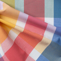 Colorful checkered tablecloth background, closeup of photo
