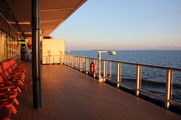 On the upper deck of a large ocean liner.