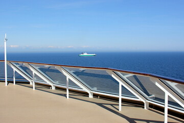 On the upper deck of a large ocean liner.