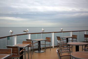 On the upper deck of a large ocean liner.