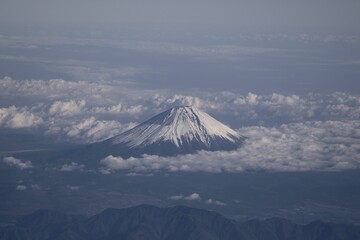 Aerial view of the majestic mount Fuji surrounded with white fluffy clouds