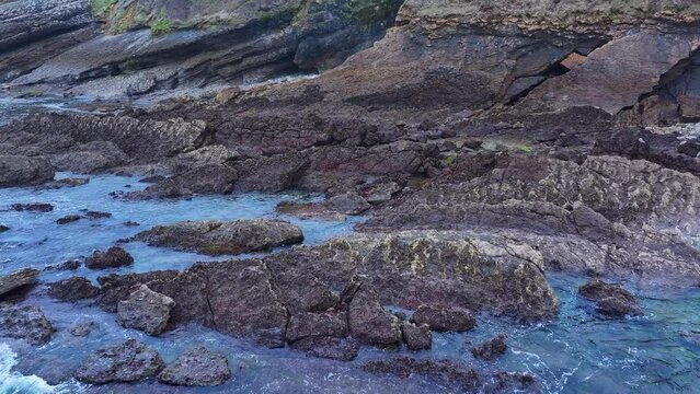 Rock formations and coastal landscape around the town of Comillas. Aerial view from a drone. Comillas Municipality. Cantabrian Sea. Cantabria. Spain. Europe
