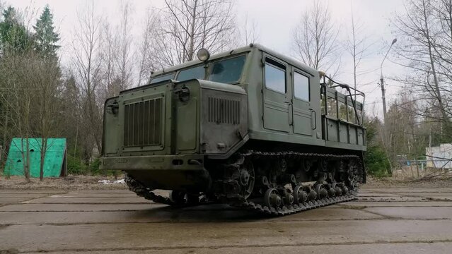 The exterior of a mid-20th century medium-track artillery tractor, designed for towing trailers, transporting people, and cargo.