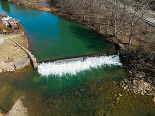 Aerial view of the Bruceton Mills waterfall gracefully flowing through a small town in West Virginia