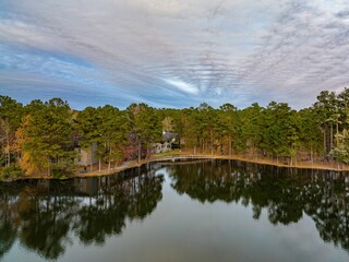Obraz premium Tranquil landscape featuring a row of trees on the edge of Harbison Lake, SC