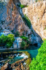 Fototapeta na wymiar Historic Dervish House on the side of a cliff near a stream in Blagaj, Bosnia and Herzegovina