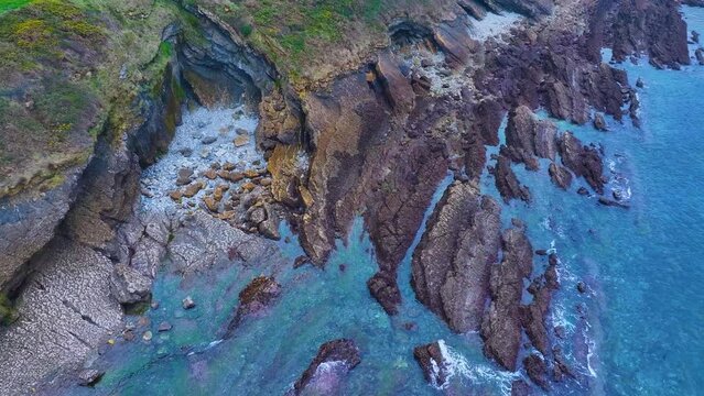 Rock formations and coastal landscape around the town of Comillas. Aerial view from a drone. Comillas Municipality. Cantabrian Sea. Cantabria. Spain. Europe