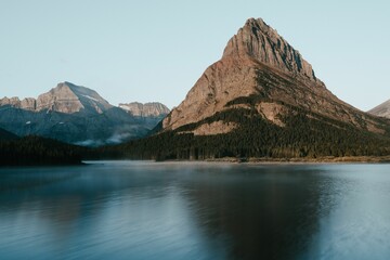 Breathtaking vista featuring Swiftcurrent Lake surrounded by snow-capped rocky mountains
