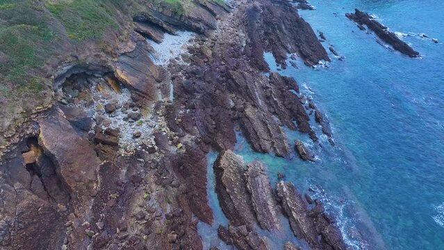 Rock formations and coastal landscape around the town of Comillas. Aerial view from a drone. Comillas Municipality. Cantabrian Sea. Cantabria. Spain. Europe