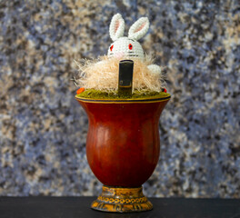 Chimarrão with Easter decoration. Yerba mate Ilex Paraguariensis. Colorful seeds of Ormosia...