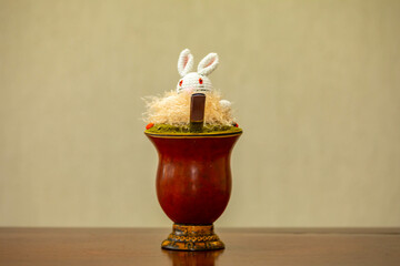Chimarrão with Easter decoration. Yerba mate Ilex Paraguariensis. Colorful seeds of Ormosia...