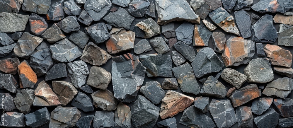 Poster a collection of rocks and bricks positioned neatly together on a black surface.