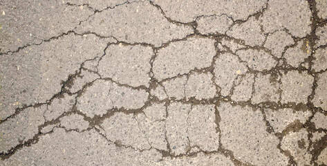 Road texture. Cracked concrete road covered with surface as background. Wall fragment with scratches and cracks.	
