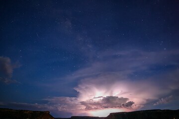 Fototapeta premium Silhouetted rock formation against a dark night sky, creating a stunningly beautiful contrast