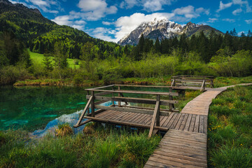 Fototapeta na wymiar Wooden footpath near lake Zelenci, Kranjska Gora, Slovenia
