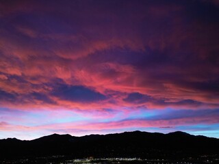 Stunning view of a cityscape at dusk, with the sky above a blend of pink hues