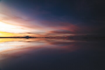 Fototapeta na wymiar Beautiful sunset mirrored in the tranquil water surface.