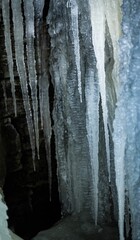 Scenic view of a cliffside, adorned with large icicles and a layer of frosted ice