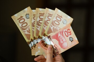 Canadian dollar bills in hands. Concept of money, banking, finance, savings