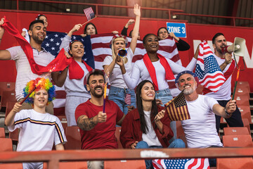 American football / soccer fans cheering at the stadium with flags and other equipment