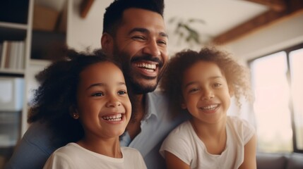 A happy smiling black family, a dad and two cute daughters with curly hair are having fun, enjoying the weekend at home.