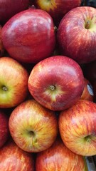 Close up pile of tasty fresh apples sold at the market as a background.